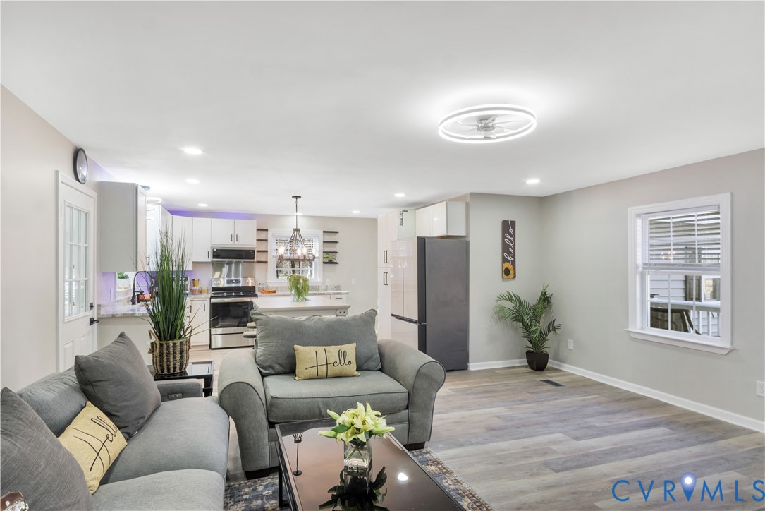 113 Red Dirt Road Williamsburg, VA 23188 - Photo 11 of 41 a living room with furniture and a chandelier
