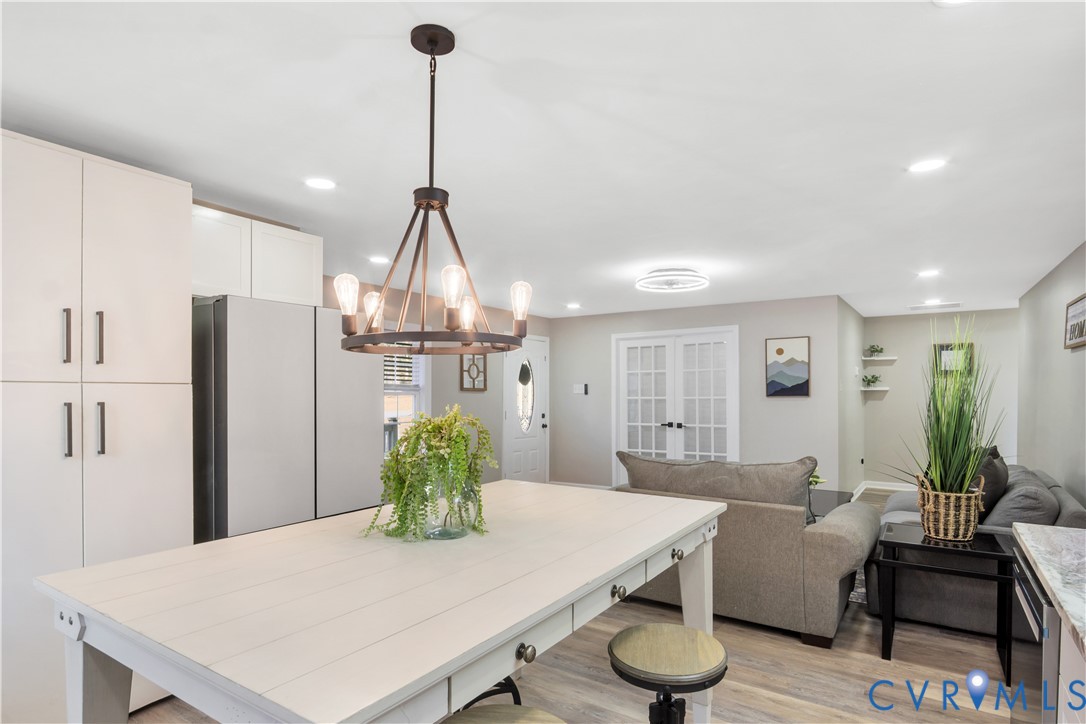 113 Red Dirt Road Williamsburg, VA 23188 - Photo 12 of 41 a living room with kitchen island furniture and a chandelier