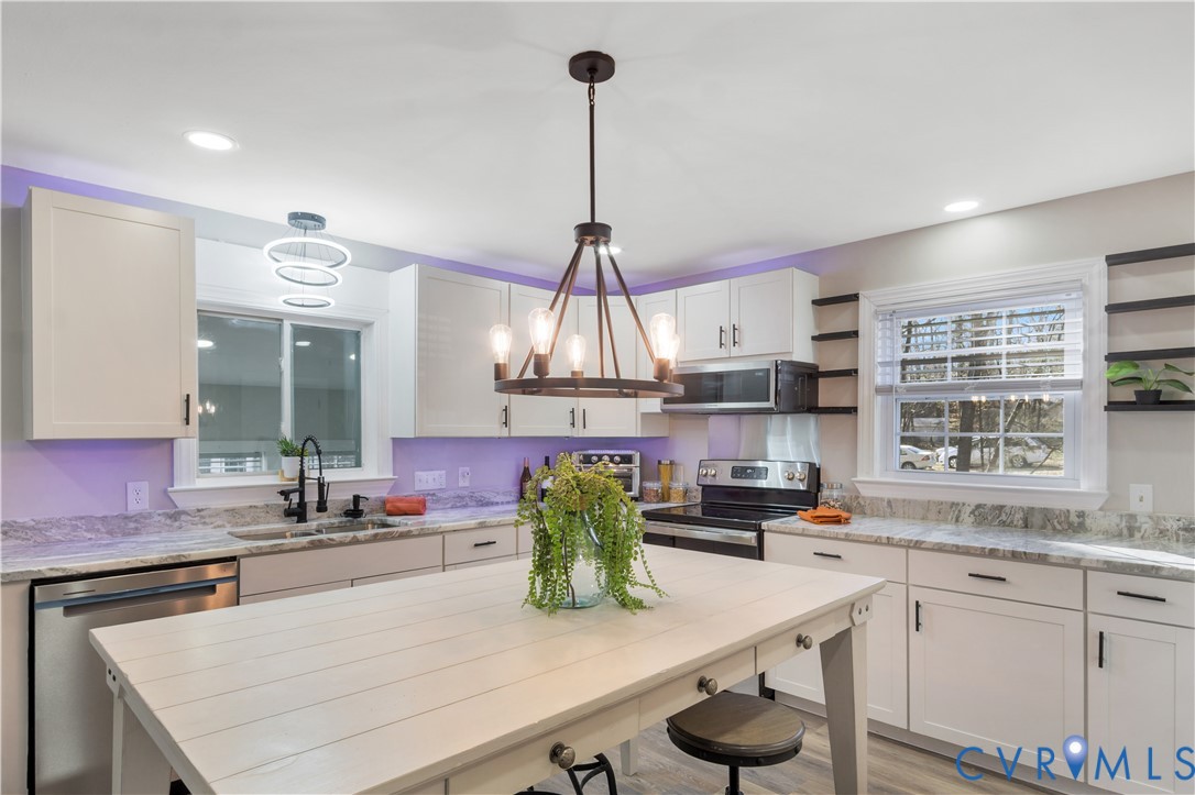 113 Red Dirt Road Williamsburg, VA 23188 - Photo 13 of 41 a kitchen with kitchen island granite countertop a sink cabinets and window