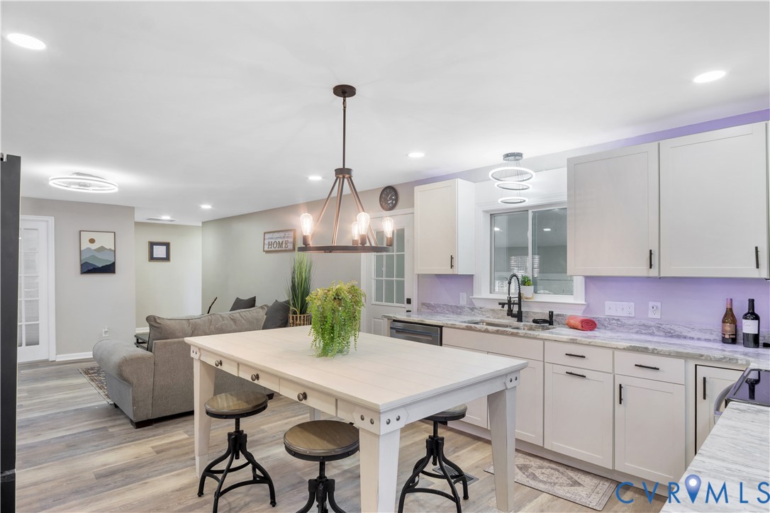 113 Red Dirt Road Williamsburg, VA 23188 - Photo 14 of 41 a kitchen with a table chairs sink and cabinets