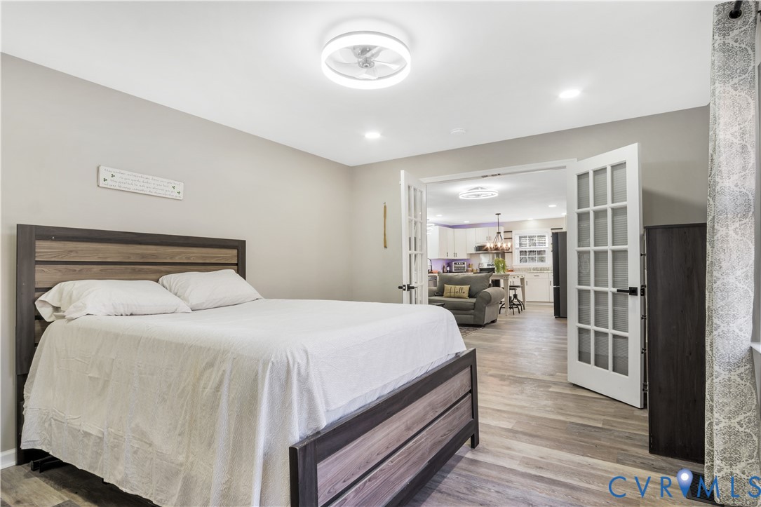 113 Red Dirt Road Williamsburg, VA 23188 - Photo 18 of 41 a bedroom with a bed and a large mirror