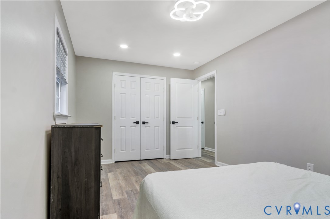 113 Red Dirt Road Williamsburg, VA 23188 - Photo 28 of 41 a large bedroom with a bed and wooden cabinets