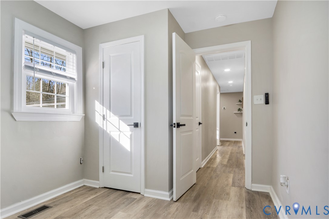 113 Red Dirt Road Williamsburg, VA 23188 - Photo 32 of 41 a view of a hallway with wooden floor and a bathroom