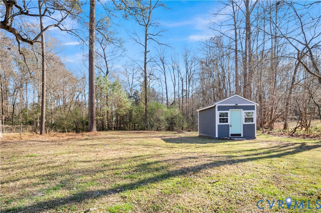 113 Red Dirt Road Williamsburg, VA 23188 - Photo 40 of 41 a large house with a large trees with yard and wooden fence