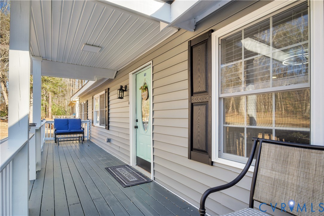 113 Red Dirt Road Williamsburg, VA 23188 - Photo 6 of 41 a view of a porch with furniture and wooden floor