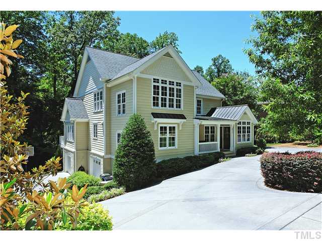 611 Runnymede Road Raleigh, NC 27607 - Photo 1 of 25 a front view of a house with a yard and potted plants
