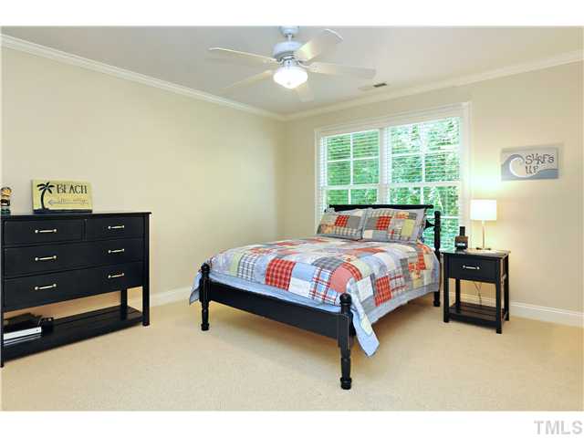 611 Runnymede Road Raleigh, NC 27607 - Photo 11 of 25 a bedroom with a bed and a chandelier