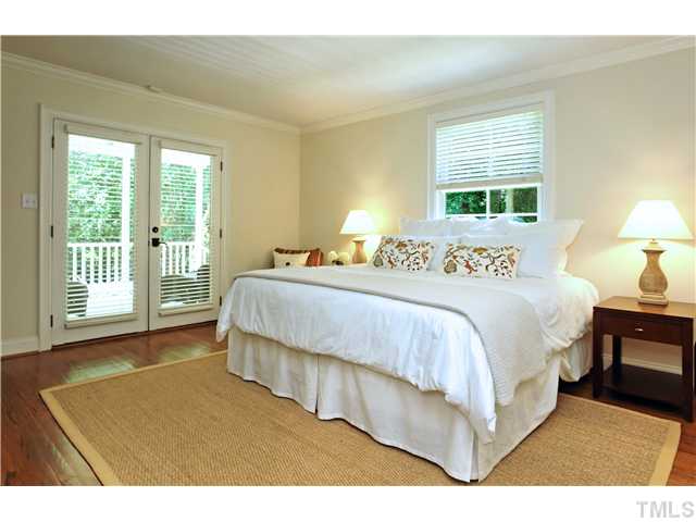 611 Runnymede Road Raleigh, NC 27607 - Photo 13 of 25 a spacious bedroom with a bed and a large window