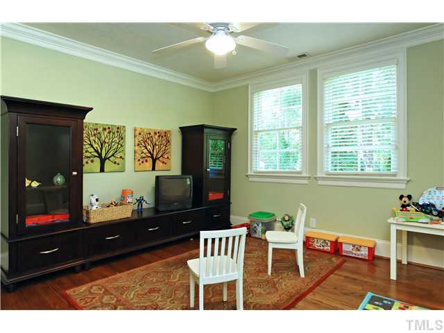 611 Runnymede Road Raleigh, NC 27607 - Photo 19 of 25 a living room with furniture and a flat screen tv