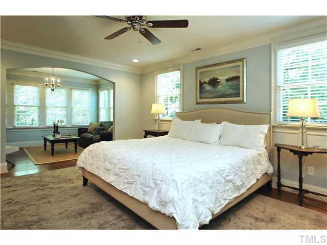 611 Runnymede Road Raleigh, NC 27607 - Photo 4 of 25 a spacious bedroom with a bed a table and potted plant with the dresser
