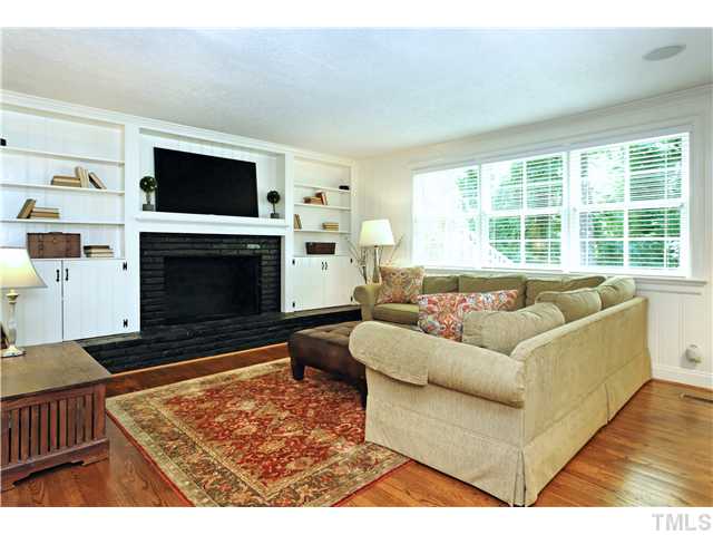 611 Runnymede Road Raleigh, NC 27607 - Photo 9 of 25 a living room with furniture a flat screen tv and a fireplace