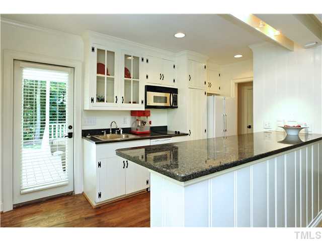 611 Runnymede Road Raleigh, NC 27607 - Photo 10 of 25 a kitchen with stainless steel appliances granite countertop a sink a stove and a refrigerator