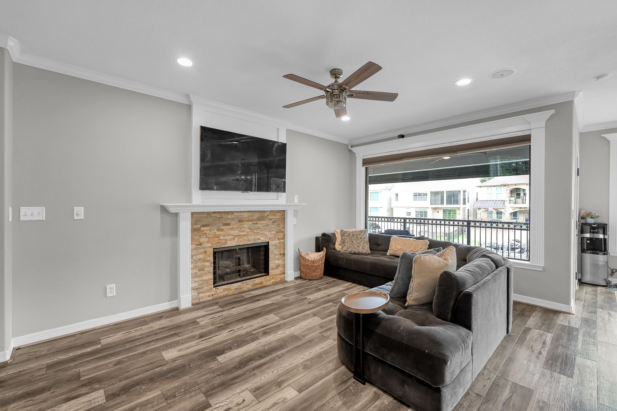 12394 Pebble View Drive Conroe, TX 77304 - Photo 11 of 49 a living room with furniture a flat screen tv and a fireplace