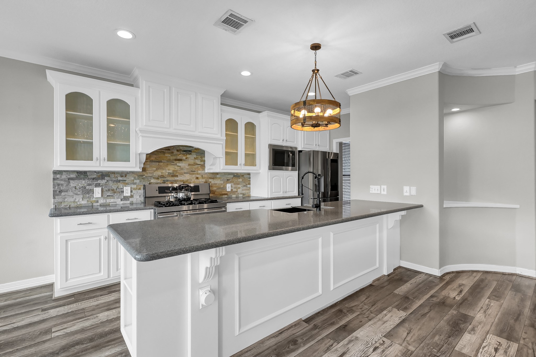 12394 Pebble View Drive Conroe, TX 77304 - Photo 13 of 49 a kitchen with stainless steel appliances granite countertop a sink a stove and a wooden floors