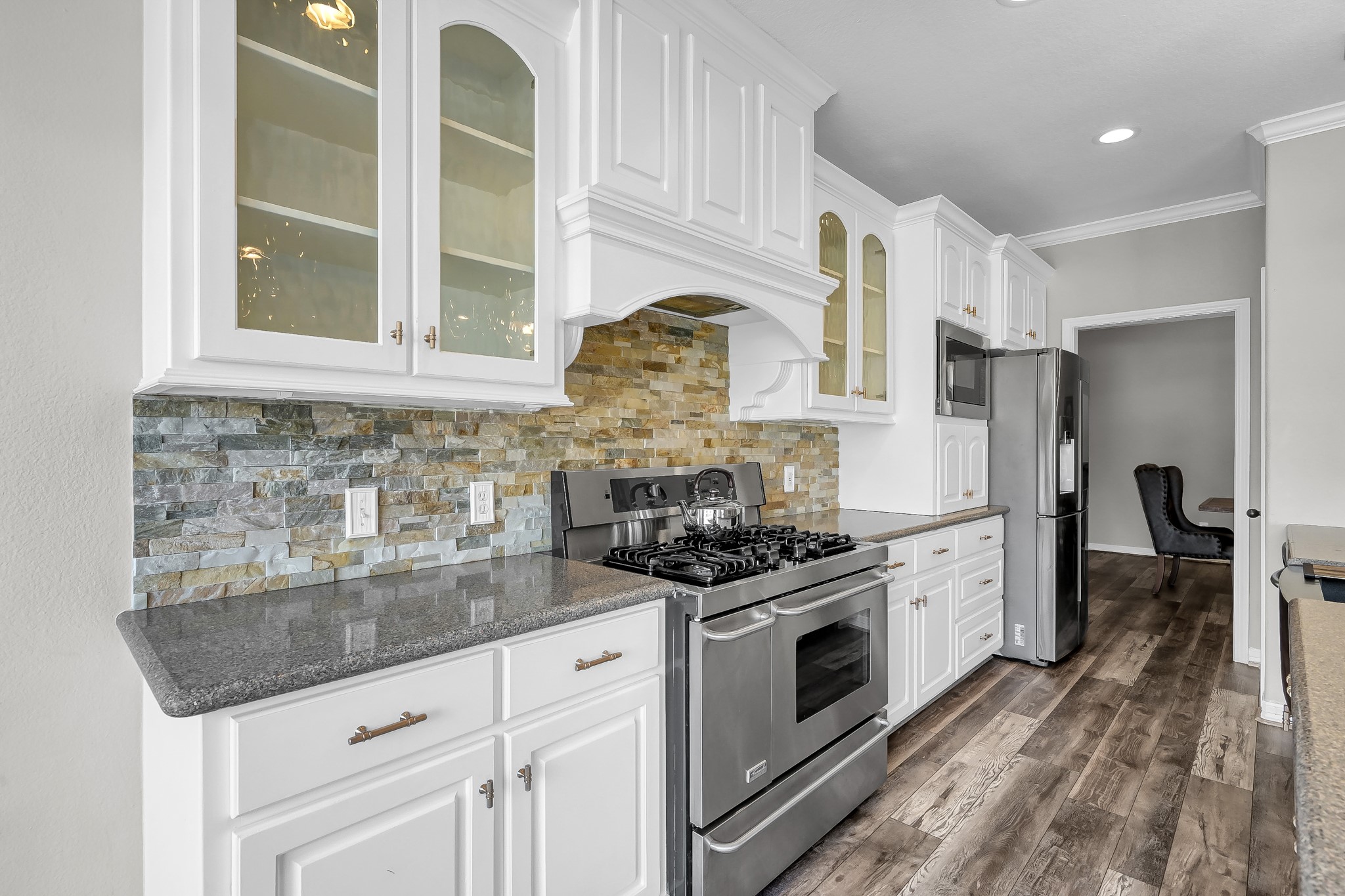12394 Pebble View Drive Conroe, TX 77304 - Photo 14 of 49 a kitchen with stainless steel appliances granite countertop a stove a sink and a refrigerator