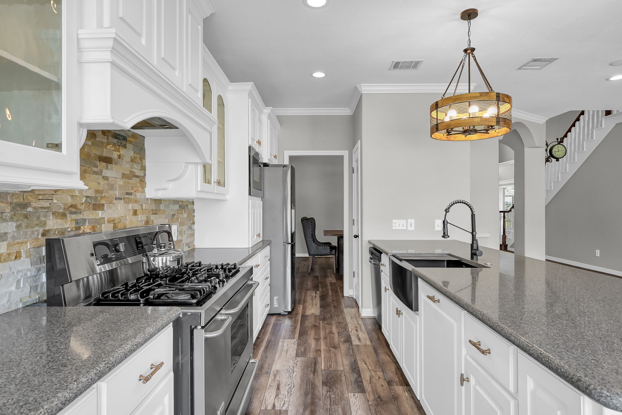 12394 Pebble View Drive Conroe, TX 77304 - Photo 15 of 49 Enjoy seamless cooking and socializing in this kitchen, with open views to the family and dining rooms.