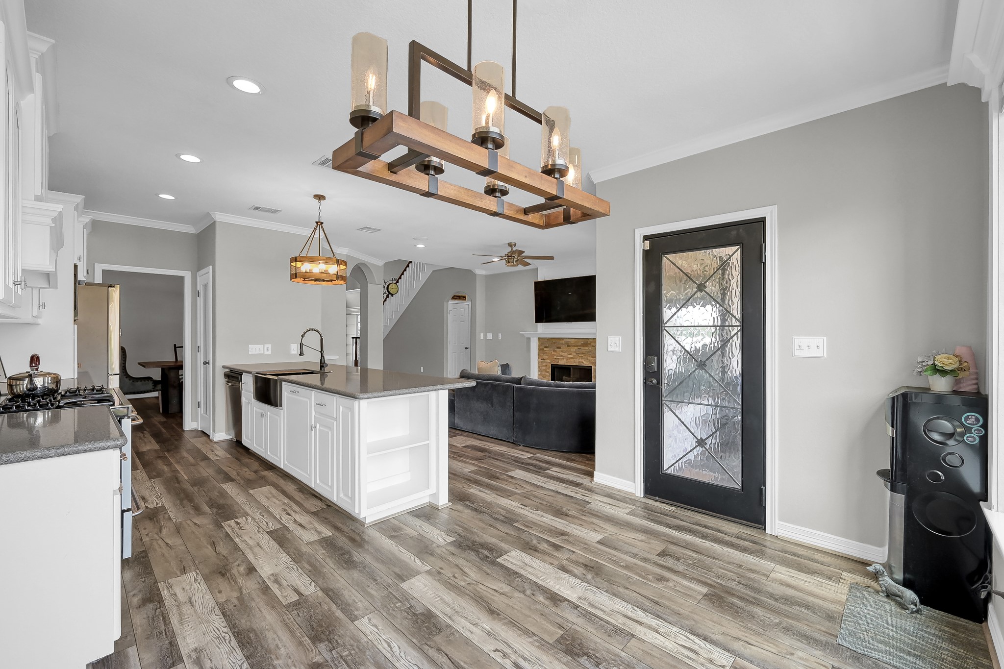 12394 Pebble View Drive Conroe, TX 77304 - Photo 17 of 49 This inviting breakfast area seamlessly connects to the kitchen and family room, featuring a stunning black iron and glass door leading to the back balcony.