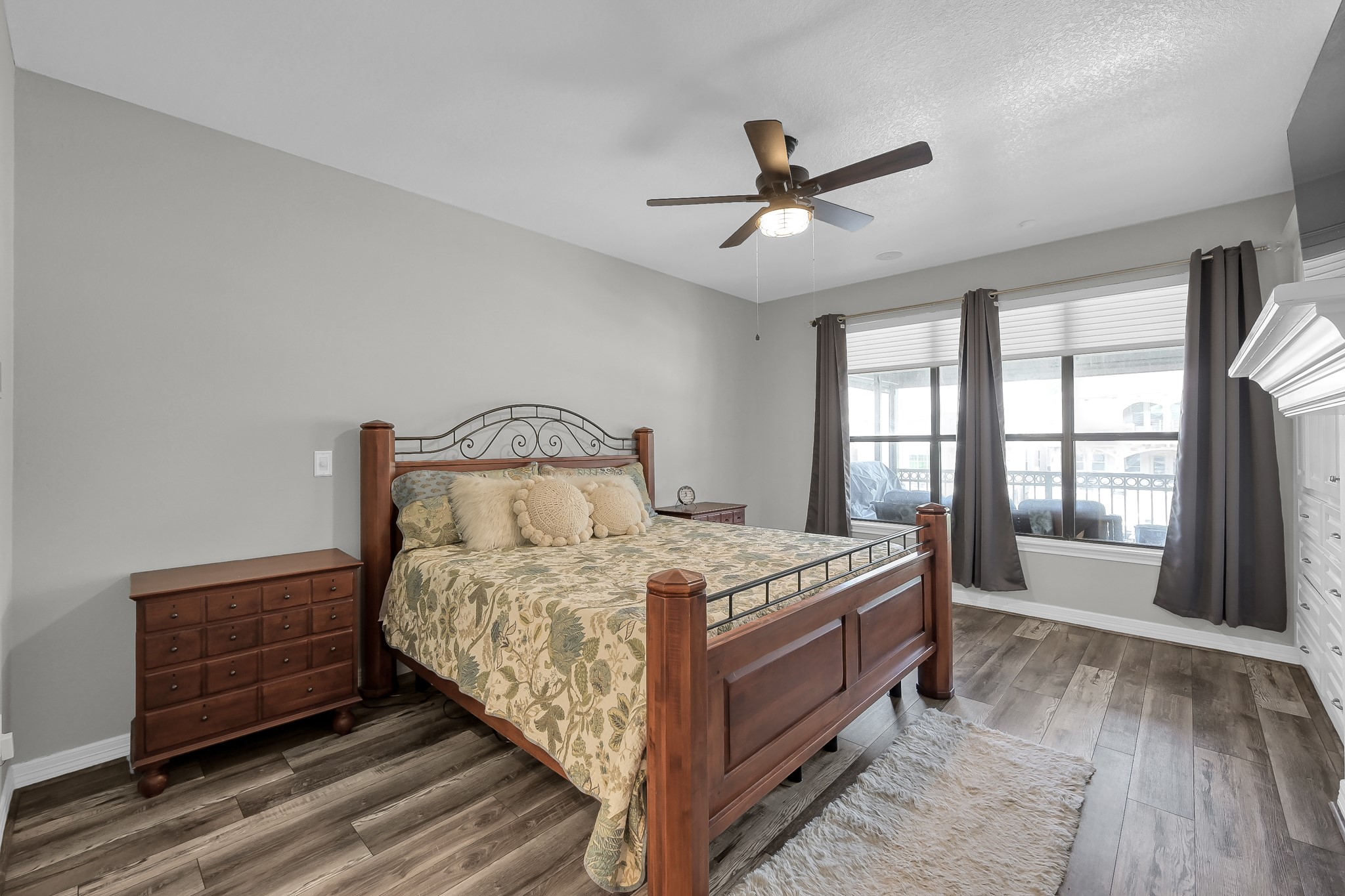 12394 Pebble View Drive Conroe, TX 77304 - Photo 19 of 49 Spacious first-floor primary bedroom with stunning lake and balcony views.