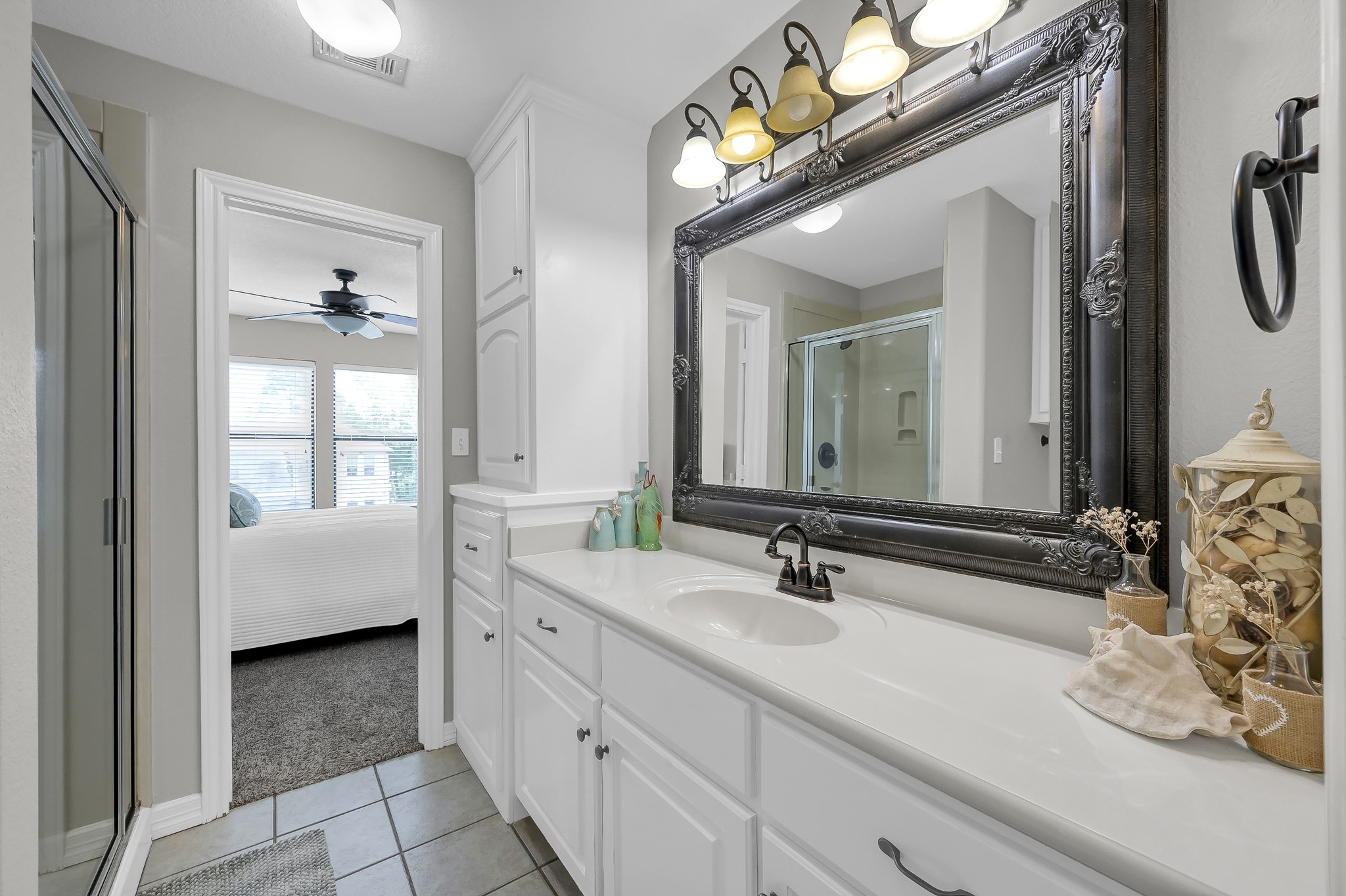 12394 Pebble View Drive Conroe, TX 77304 - Photo 28 of 49 a en suite bathroom with a double vanity sink and a mirror