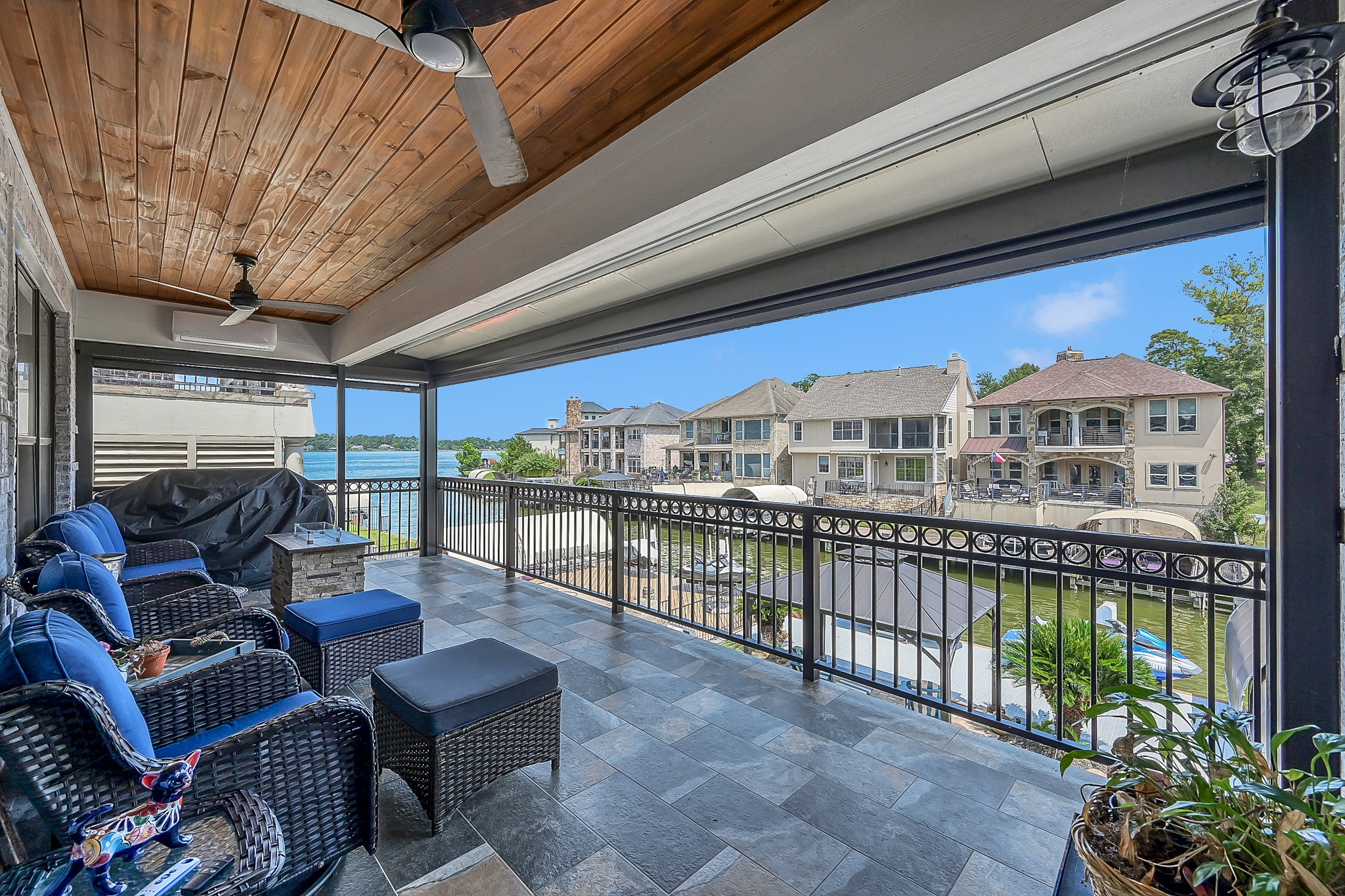 12394 Pebble View Drive Conroe, TX 77304 - Photo 32 of 49 Enjoy stunning canal and lake views from this year-round balcony, featuring automated shade screens, ceiling fans, and a climate-controlling mini split system.