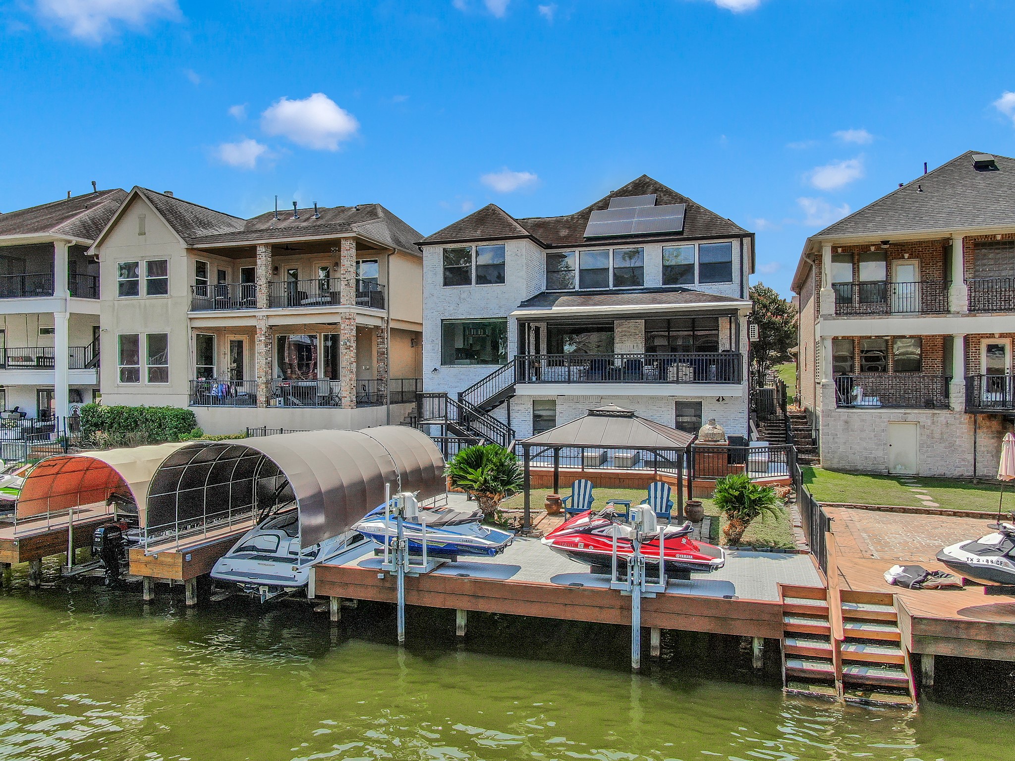 12394 Pebble View Drive Conroe, TX 77304 - Photo 40 of 49 Enjoy waterfront living with a boat slip, two jet ski lifts, and convenient stairs for easy water access.