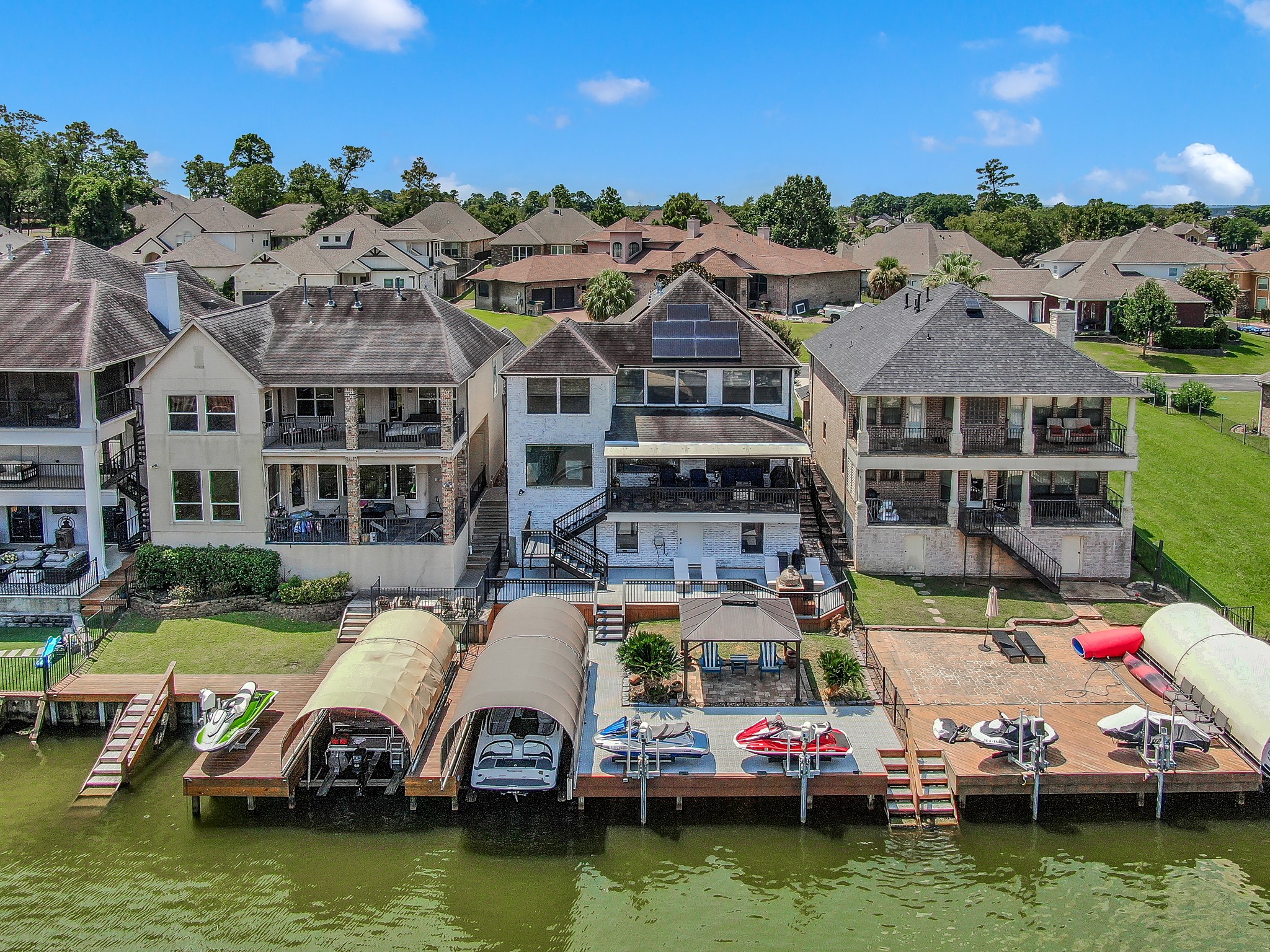 12394 Pebble View Drive Conroe, TX 77304 - Photo 42 of 49 a aerial view of a house with swimming pool lawn chairs and lake view