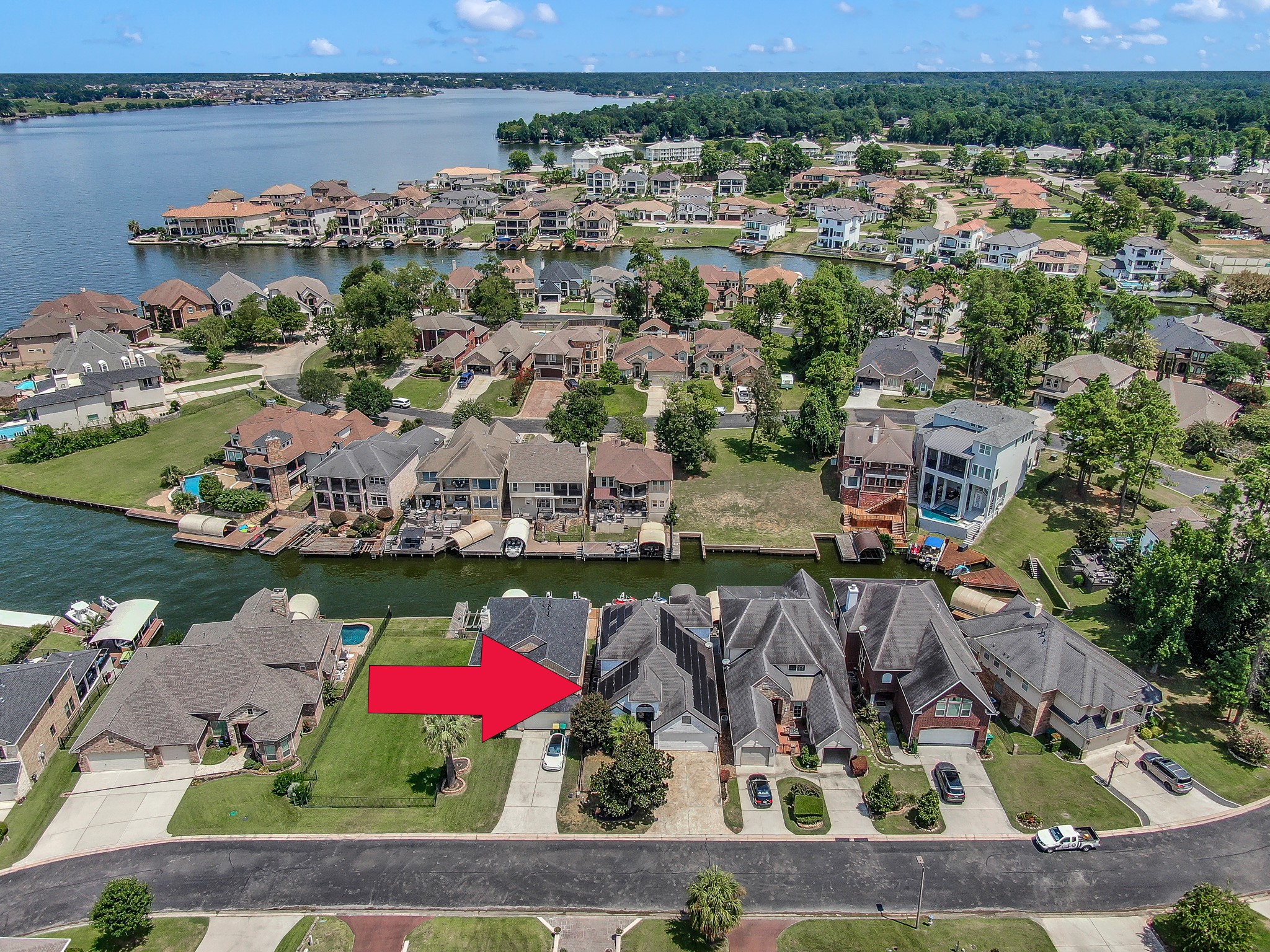 12394 Pebble View Drive Conroe, TX 77304 - Photo 48 of 49 Aerial view showing open water and canal and home marked with red arrow.