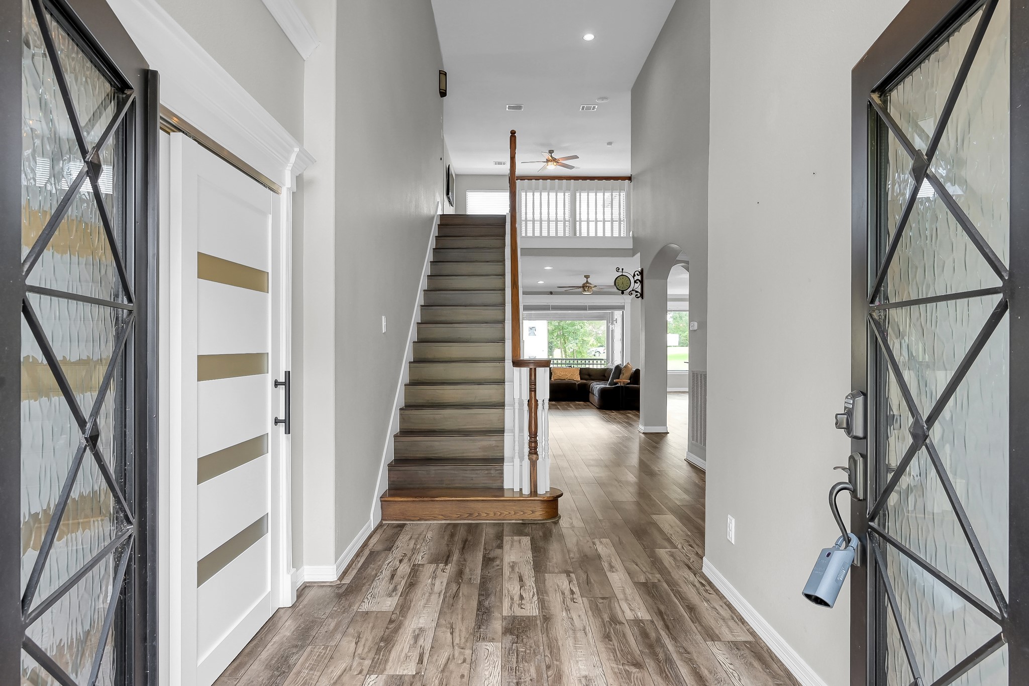 12394 Pebble View Drive Conroe, TX 77304 - Photo 5 of 49 Elegant black iron and glass double doors welcome you into a spacious foyer.