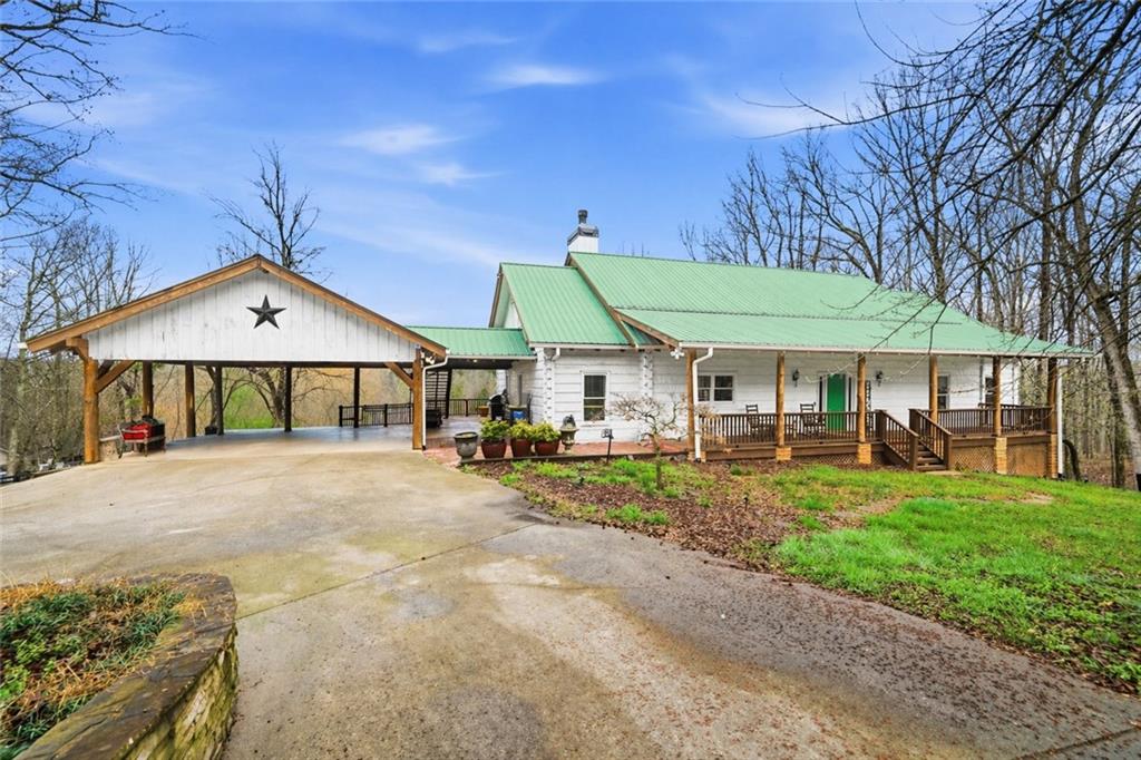 a view of a house with a yard and sitting area