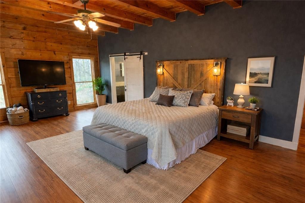 2865 Hightower Road Ball Ground, GA 30107 - Photo 16 of 41 a spacious bedroom with a bed and a flat screen tv