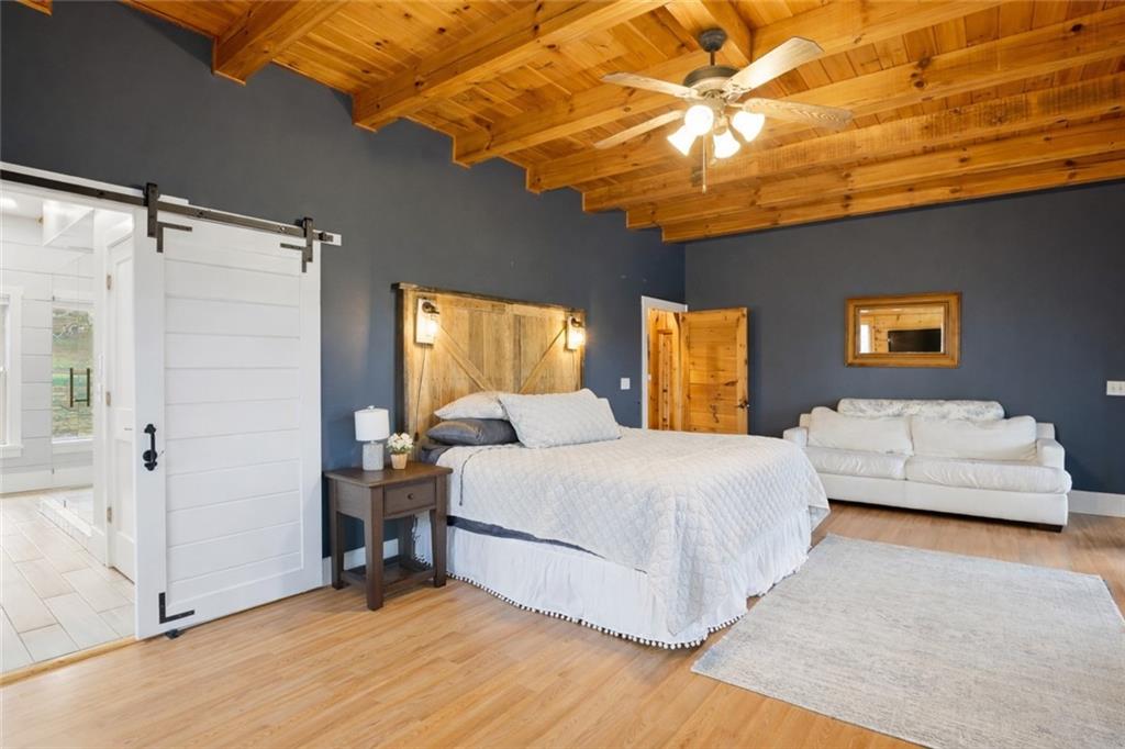 2865 Hightower Road Ball Ground, GA 30107 - Photo 17 of 41 a bedroom with a bed and a chandelier