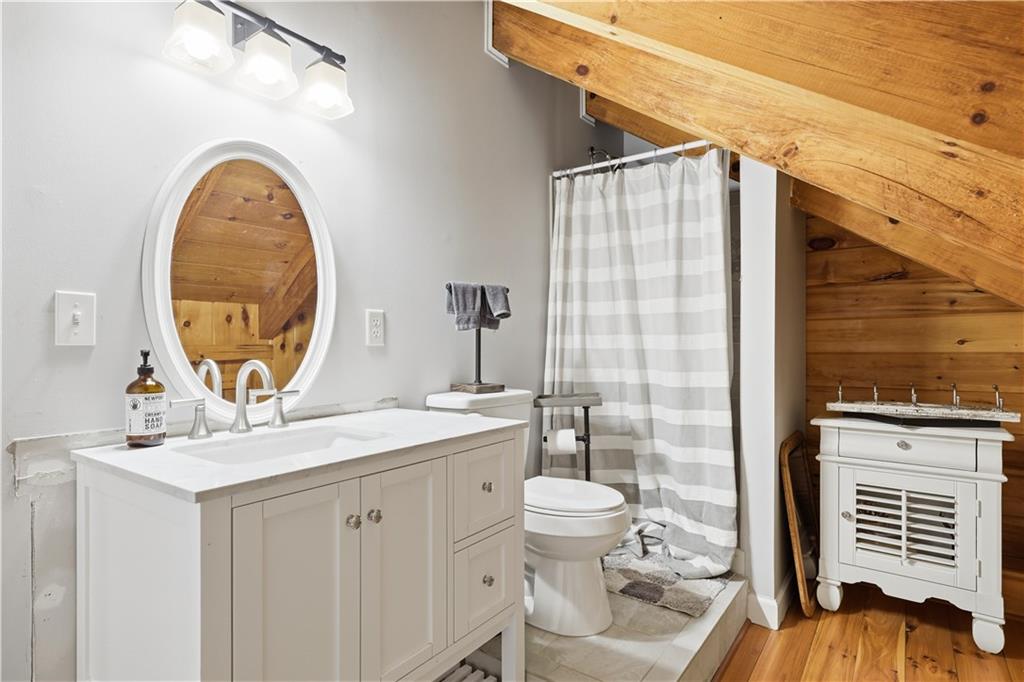 2865 Hightower Road Ball Ground, GA 30107 - Photo 26 of 41 a bathroom with a sink a mirror and a toilet
