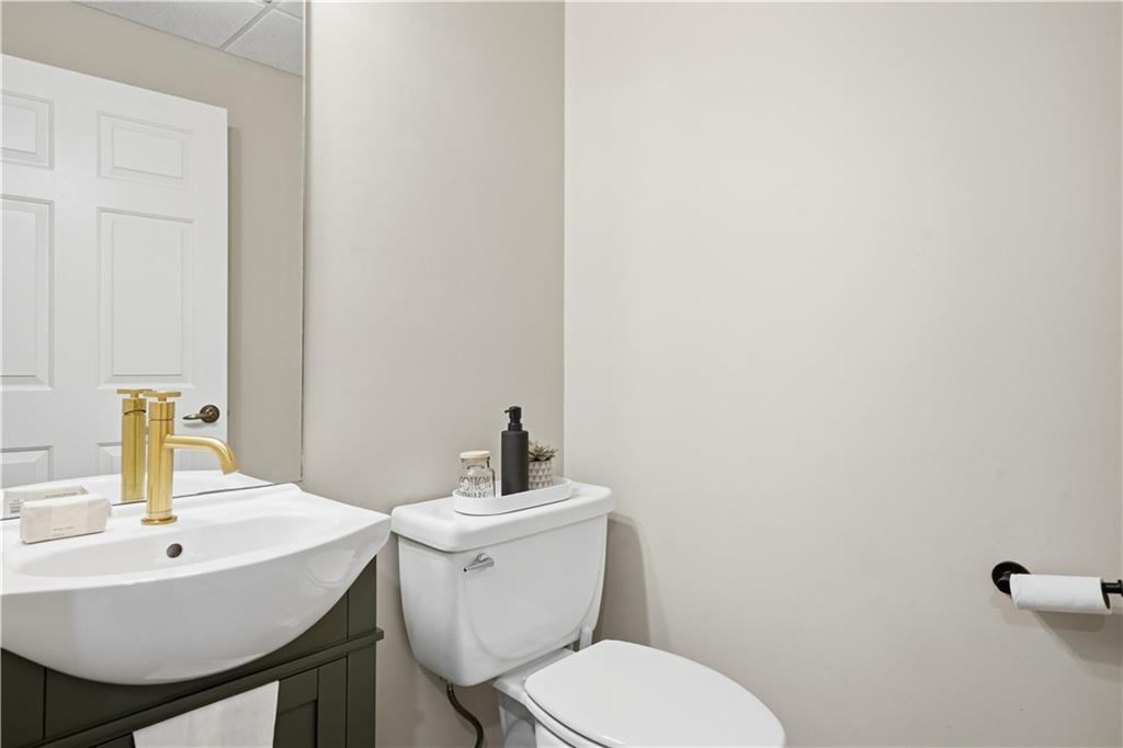 2865 Hightower Road Ball Ground, GA 30107 - Photo 34 of 41 a bathroom with a sink a toilet and mirror