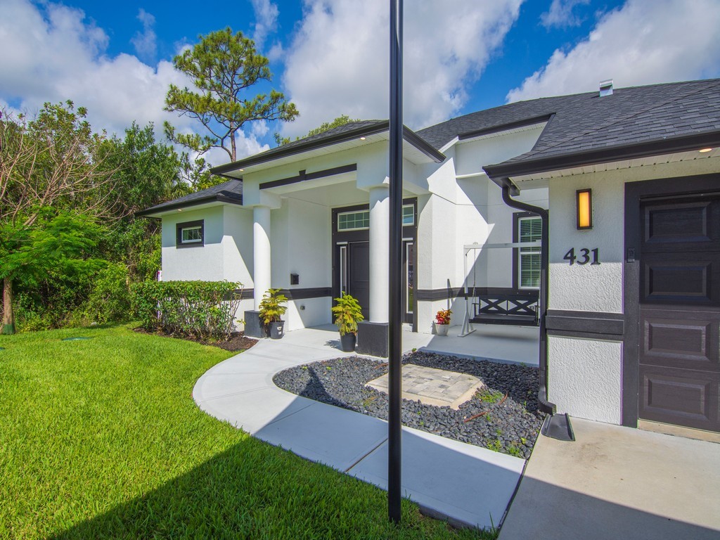 431 Midvale Terrace Sebastian, FL 32958 - Photo 3 of 34 a front view of a house with garden