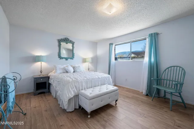 a bedroom with a bed and a chair