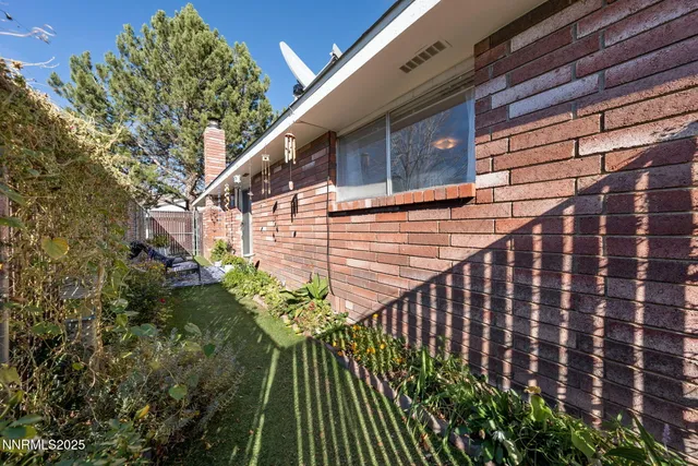 a view of a house with a flower garden