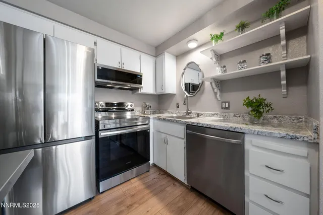 a kitchen with a sink stainless steel appliances and cabinets