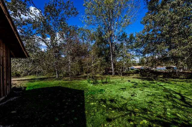 a view of a house with a big yard