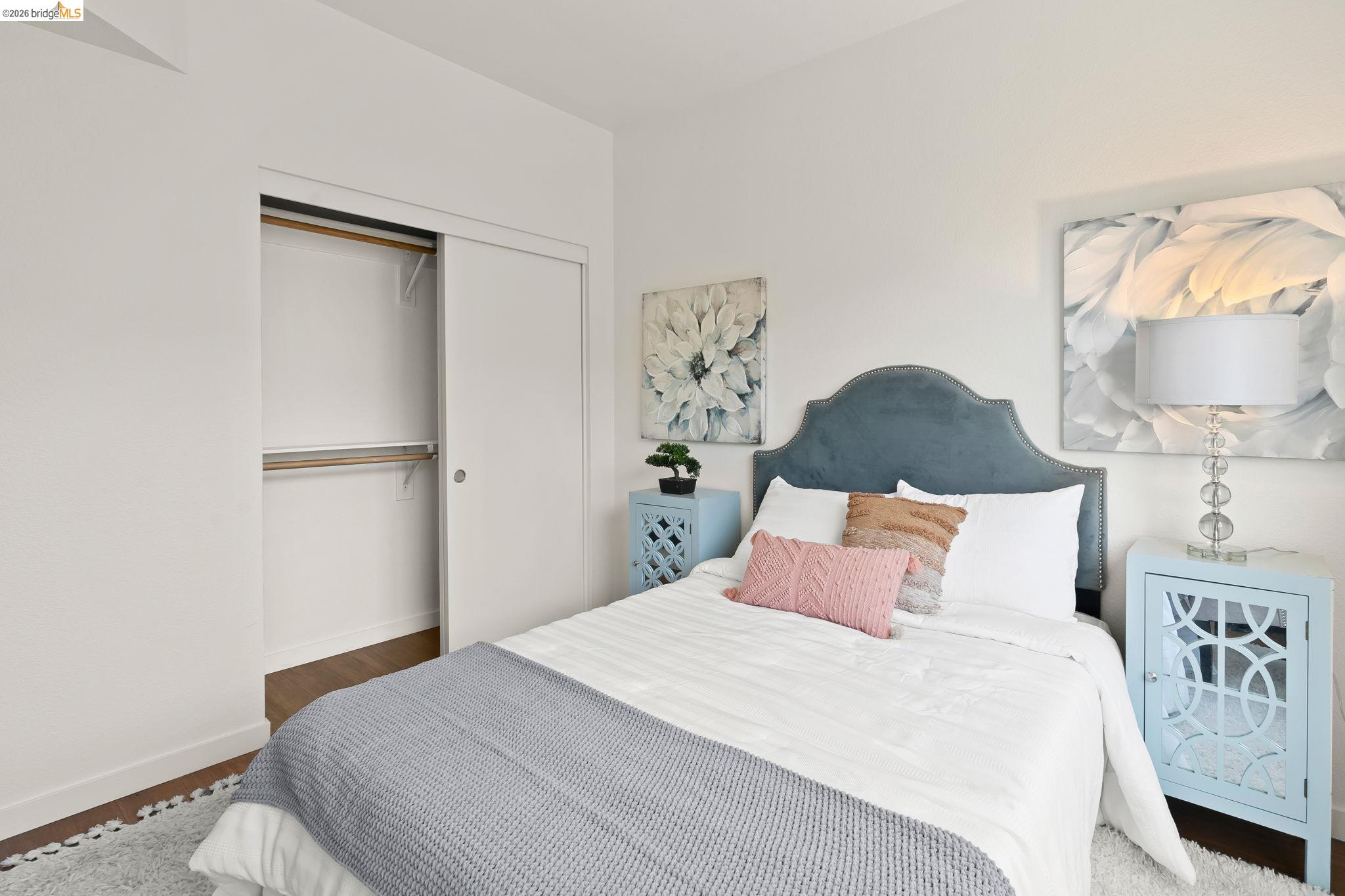 1780 12th Street Oakland, CA 94607 - Photo 19 of 31 a bedroom with a bed and a lamp