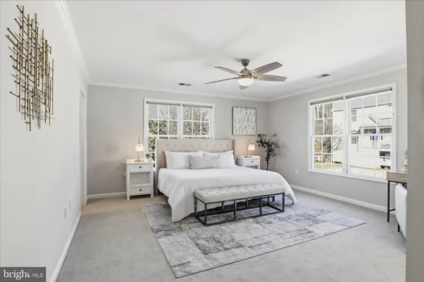 a bedroom with a large bed and a chandelier