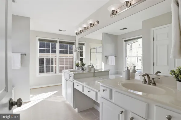 a bathroom with a granite countertop sink a toilet and bathtub