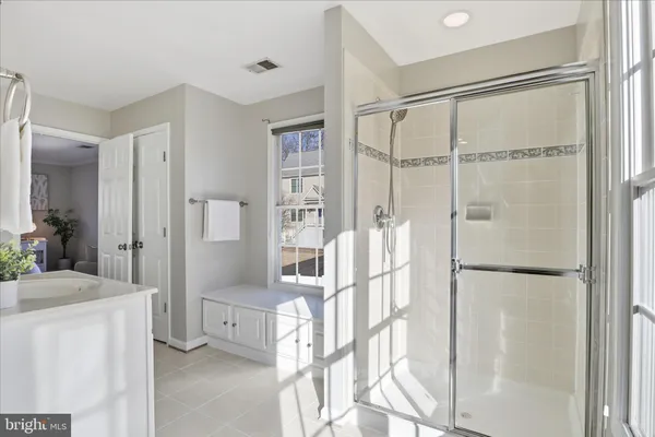 a bedroom with two beds and a large window