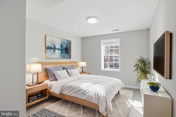 a view of a house with a small yard and wooden fence