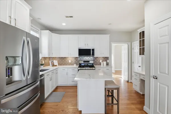 a kitchen with stainless steel appliances a stove a sink and a refrigerator