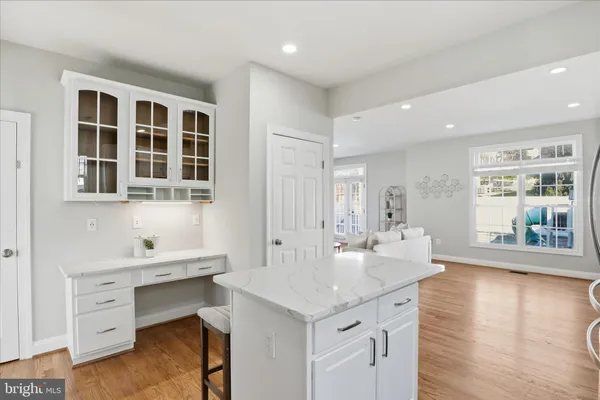 a large kitchen with stainless steel appliances a stove a sink a oven a dining table and chairs