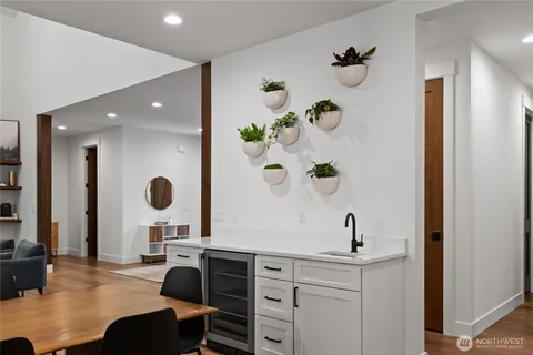 a view of kitchen with a sink dining table and chairs