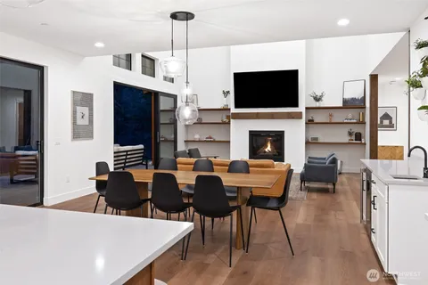 a view of a dining room with furniture wooden floor and flat screen tv