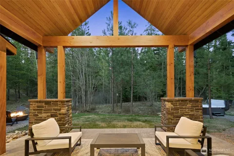 a view of a chair and table in backyard of the house
