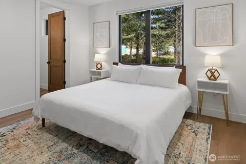 a large bed sitting in a bedroom next to a window