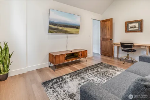 a living room with couch and a potted plant